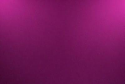 The primary subject of the image is a large, purple wall. The setting is a room with a pink background, which creates a contrasting and vibrant atmosphere. The visual style is a close-up of the wall, showcasing its color and texture. The dominant colors are purple and pink, giving the scene a warm and inviting mood.