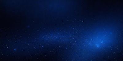 The primary subject of the image is the night sky, which is filled with stars. The setting is a dark, star-filled sky, and the visual style is a photo. The colors and mood of the image are predominantly dark and serene, with the stars providing a sense of wonder and tranquility.