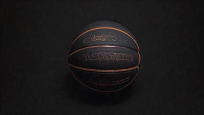 The primary subject of the image is a basketball. The setting is a dark background, which creates a contrast with the basketball. The visual style is a close-up of the basketball, showcasing its details. The colors and mood of the image are predominantly dark, with the basketball being the main focus.
