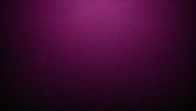 The primary subject of the image is a purple wall. The setting is a dark room, and the visual style is a close-up of the purple wall. The dominant colors are purple and black, creating a moody atmosphere.