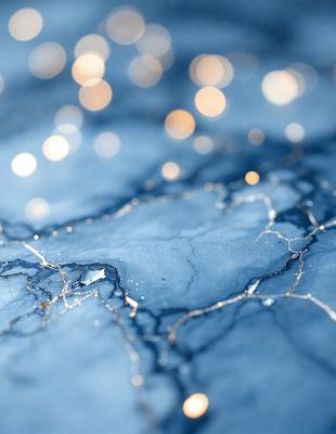 The primary subject of the image is a close-up of a marble surface with a blue tint. The setting is a dark room, and the visual style appears to be a combination of a photo and digital art. The colors and mood of the image are predominantly dark and moody, with the blue tint adding a touch of elegance and sophistication.
