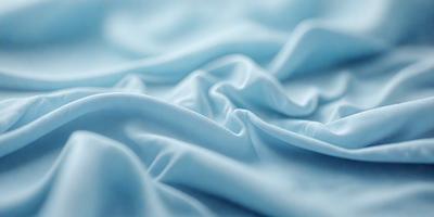 The primary subject of the image is a blue sheet or blanket. The setting is a bed, and the visual style is a close-up of the sheet. The colors and mood of the image are predominantly blue, creating a calm and soothing atmosphere.