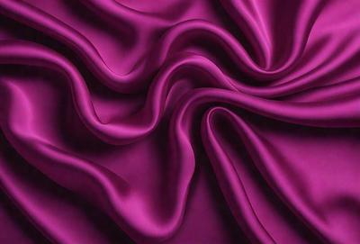 The primary subject of the image is a purple fabric, which is the main object, scene, or focus of the image. The setting/background consists of a purple curtain, and the visual style is a close-up of the fabric. The colors and mood of the image are predominantly purple, creating a calm and serene atmosphere.
