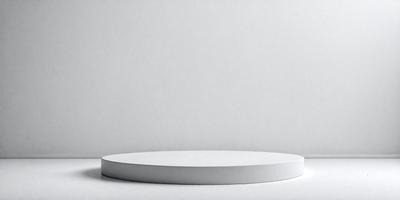 The primary subject of the image is a white, round, flat surface. The setting is a white wall, and the visual style is a photo. The colors and mood of the image are predominantly white, giving it a clean and minimalist appearance.