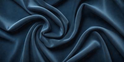 The primary subject of the image is a blue fabric, which is the main object, scene, or focus of the image. The setting or background is a blue cloth, and the visual style is a photo. The dominant colors and overall atmosphere are blue and dark, creating a moody and dramatic scene.