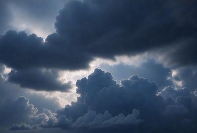 The primary subject of the image is a cloudy sky with dark clouds. The setting is an outdoor environment, and the visual style is a photo. The sky is filled with dark clouds, creating a moody atmosphere.