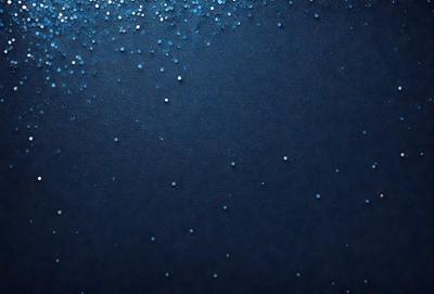 The primary subject of the image is a close-up of a blue surface with a pattern of glittering blue dots. The setting appears to be a dark room, and the visual style is a close-up of the blue surface. The colors and mood of the image are predominantly dark and moody, with the blue dots providing a touch of brightness and interest.
