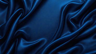 The primary subject of the image is a blue fabric, which appears to be a piece of silk. The setting is a dark room, and the visual style is a close-up of the fabric. The colors and mood of the image are predominantly dark and moody, with the blue fabric being the main focus.