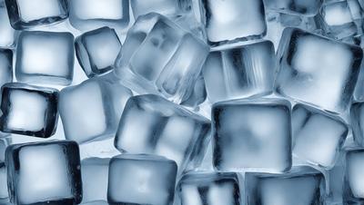 The primary subject of the image is a large group of ice cubes. The ice cubes are arranged in a visually appealing manner, creating a sense of depth and dimension. The setting is a white background, which provides a clean and uncluttered environment for the ice cubes to stand out. The visual style of the image is a close-up of the ice cubes, showcasing their intricate details and textures. The colors and mood of the image are predominantly blue, which adds a sense of