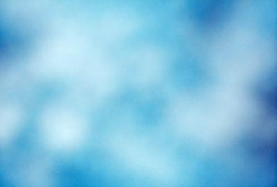 The primary subject of the image is a blue sky with a few clouds. The setting is a clear day with a cloudy sky, and the visual style is a natural, outdoor atmosphere. The colors and mood of the image are predominantly blue, creating a calm and serene ambiance.