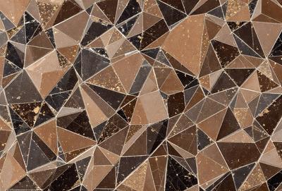 The primary subject of the image is a patterned surface, which appears to be a tile or a piece of artwork. The setting is a room with a brown and tan color scheme. The visual style is a combination of digital art and illustration, creating a unique and intricate design. The colors and mood of the image are warm and inviting, with the brown and tan tones creating a sense of comfort and familiarity.