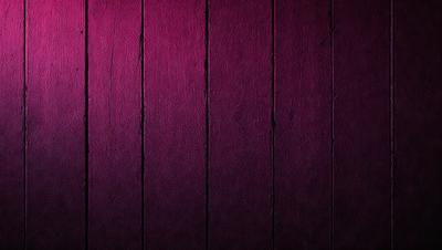 The primary subject of the image is a wooden wall with a purple color. The setting is a room with a wooden surface, and the visual style is a close-up of the wooden wall. The dominant colors are purple and brown, creating a warm and cozy atmosphere.