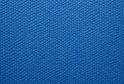 The primary subject of the image is a blue surface with a pattern of small circles. The setting is a blue background, and the visual style appears to be a pattern or texture. The dominant colors are blue and white, creating a calm and soothing atmosphere.