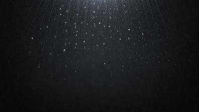 The primary subject of the image is a rainy night with a dark sky. The setting is a nighttime scene with a black background, and the visual style is a photo. The colors and mood of the image are dark and moody, with the rain creating a sense of gloom.