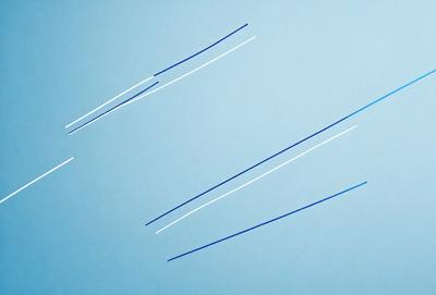 The primary subject of the image is a blue line that is stretched across the entire frame. The setting is a blue background, which creates a sense of depth and contrast. The visual style is a simple, clean line that stands out against the blue background. The colors and mood of the image are predominantly blue, creating a calm and serene atmosphere.