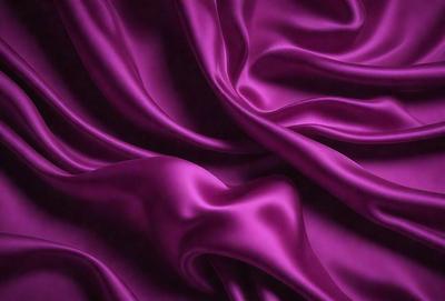 The primary subject of the image is a purple fabric, which is the main object, scene, or focus of the image. The setting or background is a purple curtain, and the visual style is a photo. The colors and mood of the image are predominantly purple, creating a calm and serene atmosphere.