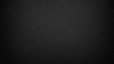 The primary subject of the image is a black background. The setting is a dark, empty space with no visible objects or elements. The visual style is a simple, monochromatic design. The colors and mood are predominantly dark and moody, creating a sense of mystery or drama.