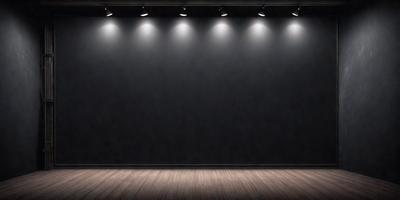 The primary subject of the image is a black stage with a black curtain. The setting is a theater or a stage, and the visual style is a black and white photo. The colors and mood of the image are dark and dramatic, creating a sense of mystery and anticipation.