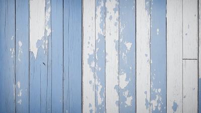 The primary subject of the image is a blue and white striped wall. The setting is a room with a wooden floor. The visual style is a photo of the wall, showcasing the blue and white stripes. The colors and mood of the image are predominantly blue and white, creating a clean and classic atmosphere.