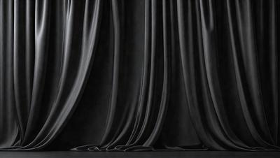 The primary subject of the image is a black curtain, which is the main object and focus of the scene. The curtain is hanging on a stage, creating a dramatic and theatrical atmosphere. The setting is a stage, with the curtain as the primary visual element. The visual style is a black and white photo, which adds to the dramatic and artistic mood of the image.