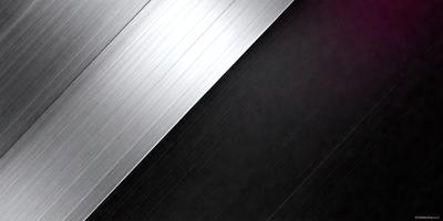 The primary subject of the image is a silver metal surface, which appears to be a metal sheet or a metal wall. The setting is a dark room, and the visual style is a close-up of the metal surface. The colors and mood of the image are predominantly dark, with the silver metal surface being the main focal point.