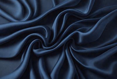 The primary subject of the image is a blue fabric, which appears to be a piece of cloth or a curtain. The setting is a dark room, and the visual style is a close-up of the blue fabric. The colors and mood of the image are predominantly dark and moody, with the blue fabric being the main focus.