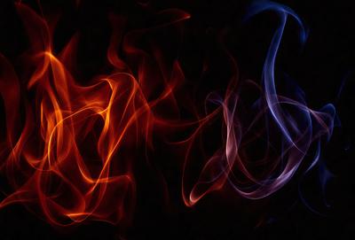 The primary subject of the image is a pair of flames, with one being orange and the other being blue. The setting is a dark background, which contrasts with the bright colors of the flames. The visual style appears to be a digital art or illustration, as the flames are depicted in a stylized manner. The dominant colors are orange and blue, creating a striking and visually appealing contrast. The overall atmosphere of the image is one of intensity and energy, as the flames seem to be burning with a