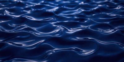 The primary subject of the image is a large body of blue water, which appears to be a deep blue ocean. The setting is underwater, with the water being the primary background. The visual style of the image is a photo, capturing the beauty of the deep blue ocean. The colors and mood of the image are predominantly blue, creating a serene and calming atmosphere.
