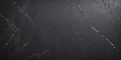 The primary subject of the image is a black marble countertop. The setting is a dark room, and the visual style is a close-up of the marble countertop. The countertop appears to be textured and has a dark, moody atmosphere.