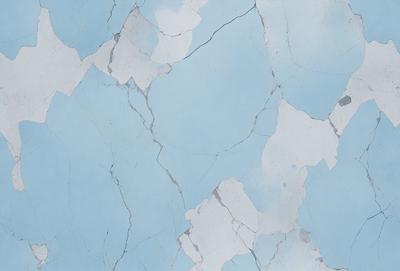 The primary subject of the image is a blue and white marble wall with a cracked and chipped appearance. The setting is a room with a blue background. The visual style is a close-up of the marble wall, showcasing its unique texture and design. The colors and mood of the image are predominantly blue and white, creating a sense of elegance and sophistication.