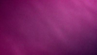 The primary subject of the image is a pink background. The setting is a dark, purple-pink room. The visual style is a close-up of the pink background, which creates a moody and dramatic atmosphere.
