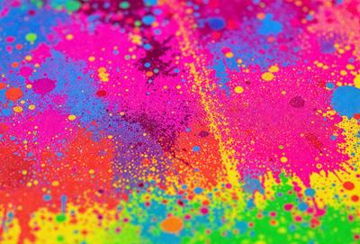 The primary subject of the image is a colorful, abstract painting featuring a variety of colors and patterns. The setting is a table, and the visual style appears to be a combination of digital art and illustration. The dominant colors and overall atmosphere of the painting are vibrant, lively, and energetic.