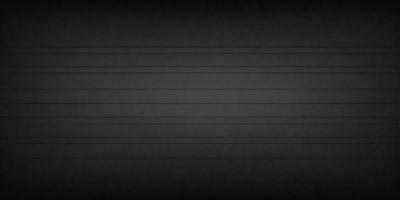 The image is a black and white photo of a dark background.