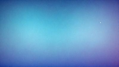 The primary subject of the image is a large, open, and empty blue sky. The setting is a vast, cloudless expanse, with no visible landmarks or objects. The visual style is a natural, untouched landscape, with no indication of digital manipulation or artistic elements. The colors and mood are predominantly blue, creating a serene and tranquil atmosphere.