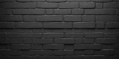 The primary subject of the image is a black brick wall. The setting is a dark room, and the visual style is a close-up of the brick wall. The colors and mood of the image are predominantly dark, with the black brick wall being the main focus.