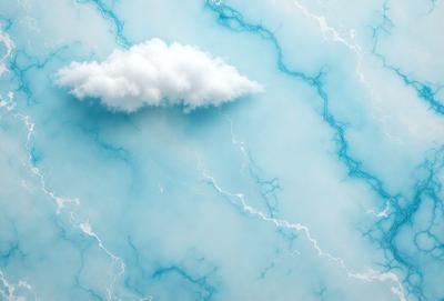 The primary subject of the image is a cloud, which is floating in the sky. The setting is a blue marble surface, possibly a wall or a countertop. The visual style appears to be a photo, as the cloud is captured in a natural environment. The colors and mood of the image are predominantly blue, creating a calm and serene atmosphere.