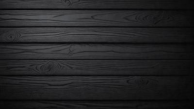 The primary subject of the image is a wooden wall. The setting is a dark room, and the visual style is a black and white photo. The colors and mood of the image are predominantly dark, creating a moody atmosphere.