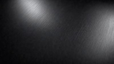 The primary subject of the image is a shiny, reflective surface. The setting is a dark room, and the visual style appears to be a photo. The colors and mood of the image are predominantly dark, with the shiny surface being the main focal point.