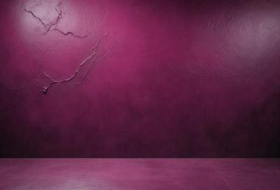 The primary subject of the image is a purple wall with a pattern of branches. The setting is a room with a purple wall, and the visual style is a photo. The dominant colors are purple and pink, creating a calm and soothing atmosphere.