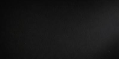 The primary subject of the image is a black background. The setting is a dark room, and the visual style is a black and white photo. The colors and mood of the image are predominantly dark and moody, creating a dramatic atmosphere.