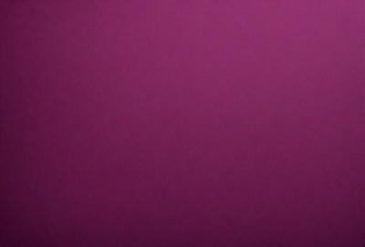 The primary subject of the image is a large, purple wall. The setting is a room with a pink background. The visual style is a close-up of the purple wall, which gives a sense of depth and texture. The colors and mood of the image are predominantly purple, creating a calm and serene atmosphere.