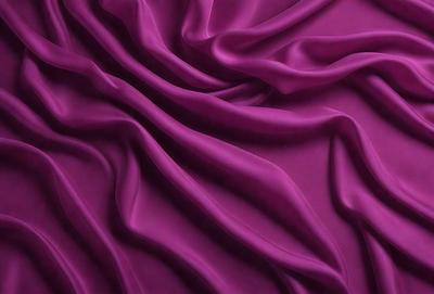The primary subject of the image is a purple fabric, which is the main object, scene, or focus of the image. The setting or background is a purple sheet, and the visual style is a photo. The colors and mood of the image are predominantly purple, creating a calm and soothing atmosphere.
