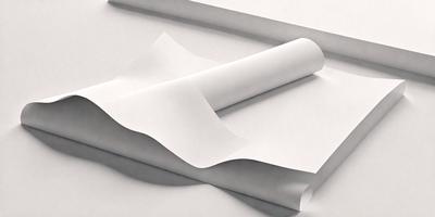 The primary subject of the image is a white sheet of paper. The setting is a table, and the visual style is a photo. The colors and mood of the image are predominantly white, giving it a clean and minimalist appearance.