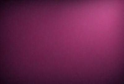 The primary subject of the image is a large, pink wall. The setting is a room with a pink background, and the visual style is a close-up of the wall. The dominant colors in the image are pink, and the overall atmosphere is warm and inviting.