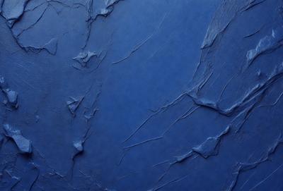 The primary subject of the image is a blue wall with a textured surface. The setting is a room with a blue background. The visual style is a close-up of the blue wall, which gives a sense of depth and texture. The dominant colors are blue and grey, creating a calm and soothing atmosphere.