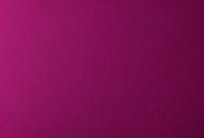 The primary subject of the image is a large, purple wall. The setting is a room with a pink background, which creates a warm and inviting atmosphere. The visual style is a close-up of the wall, showcasing its texture and color. The dominant colors are pink and purple, giving the image a soft and calming mood.