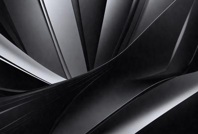 The primary subject of the image is a spiral-shaped structure, possibly a staircase or a tunnel, made of metal. The setting is a dark room, with the spiral structure being the main focus of the image. The visual style appears to be a black and white photo, giving the image a classic and timeless feel. The colors and mood of the image are predominantly dark, with the spiral structure being the only light source, creating a sense of depth and intrigue.