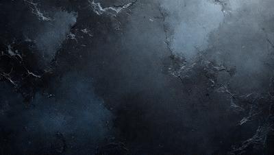 The primary subject of the image is a black and white photo of a wall with a blue tint. The setting is a dark room, and the visual style is a close-up of the wall. The colors and mood of the image are predominantly dark and moody, with the blue tint adding a touch of coolness to the overall atmosphere.
