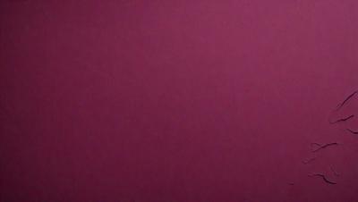 The primary subject of the image is a large, purple wall. The setting is a room with a pink background. The visual style is a close-up of the wall, which gives a sense of depth and texture. The dominant colors are purple and pink, creating a warm and inviting atmosphere.