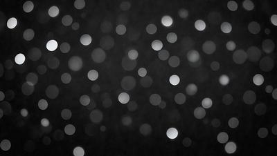 The primary subject of the image is a night sky filled with bright, white stars. The setting is a dark, black background that contrasts with the bright stars. The visual style is a black and white photo, which adds a timeless and classic feel to the image. The colors and mood are predominantly dark and moody, with the bright stars providing a touch of light and beauty in the otherwise dark and mysterious environment.